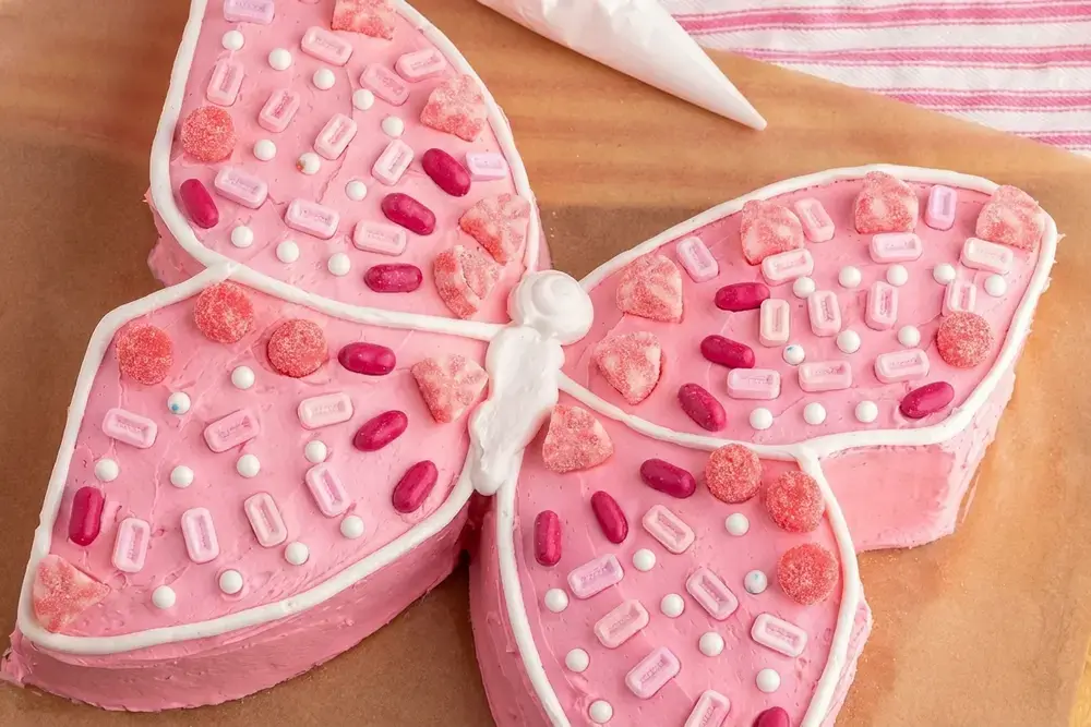 Using just a box of cake mix, premade icing, and a few simple steps, you can transform an ordinary cake into a fluttering butterfly cake that will wow everyone at your table!