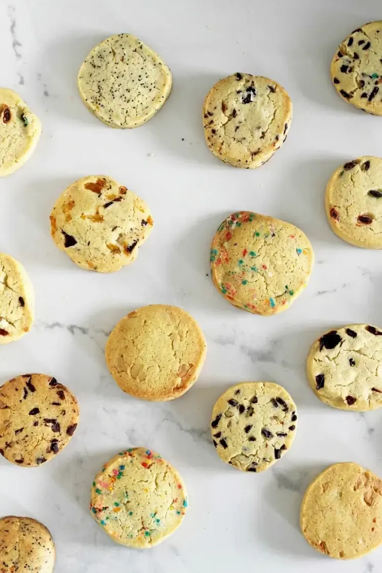 This recipe for easy slice and bake cookies comes with 9 flavour ideas! Perfect for school lunches or homemade gifts, the cookie dough can be made in advance and frozen for cookies in a snap!