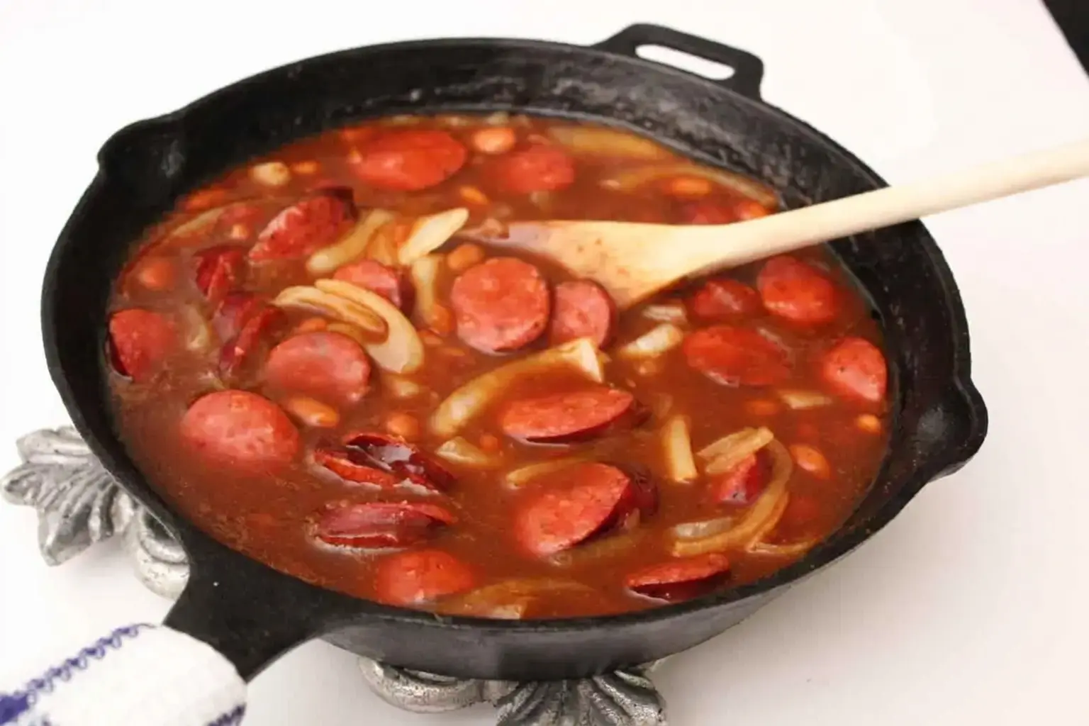 Chicken fajitas cooking in a cast iron skillet at camp