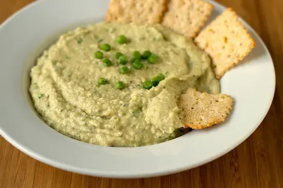 8 Great Garlic Scape Recipes for Pesto, Hummus, and More 3 Green garlic scape pesto in a serving bowl