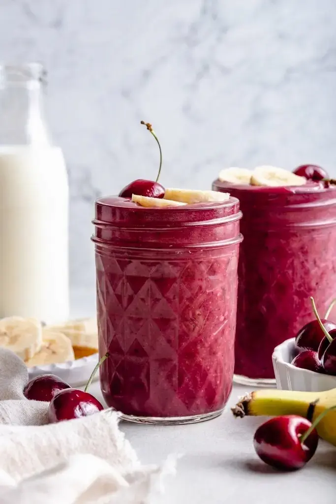Banana cherry smoothie served fresh in a glass