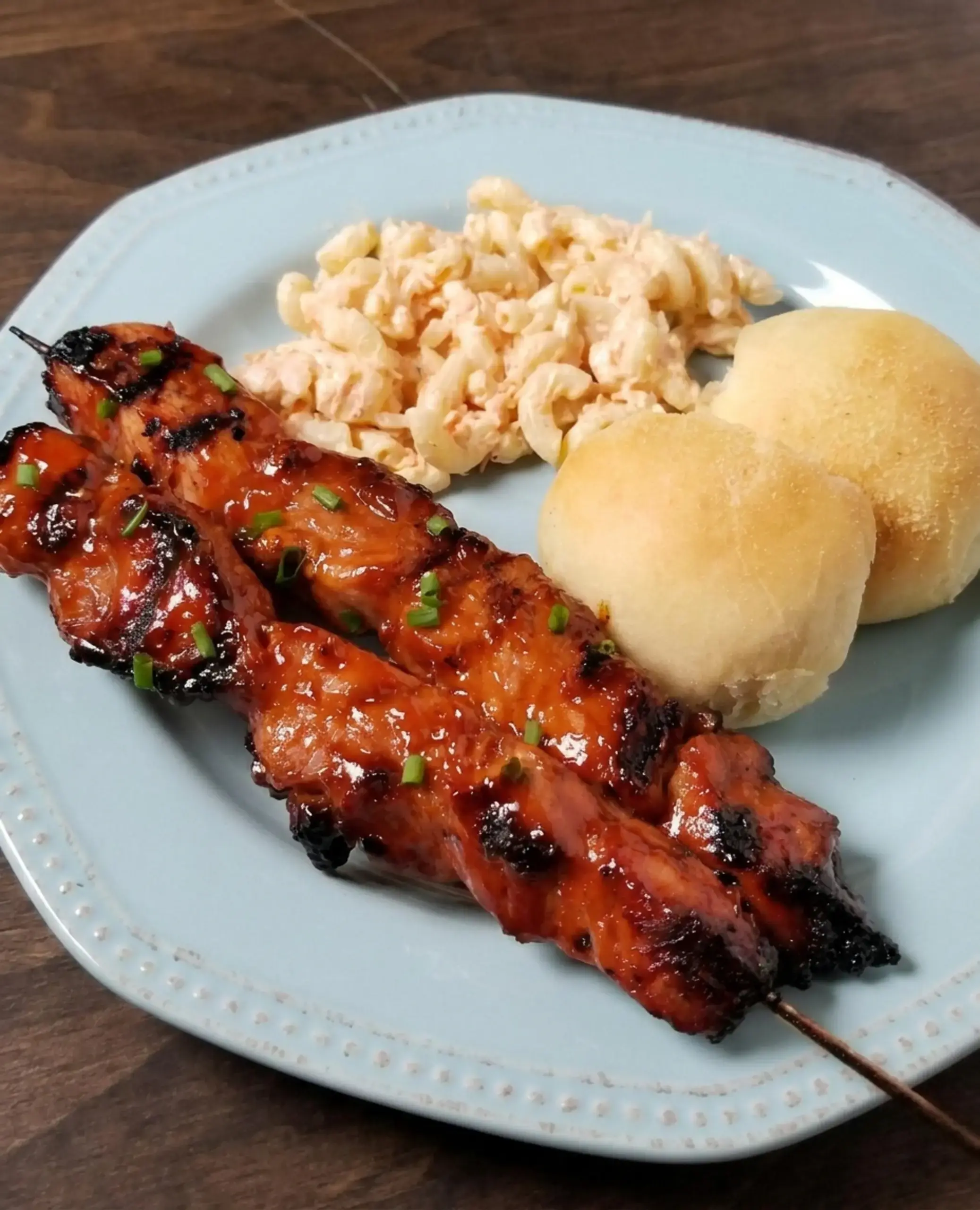Marinated pork strips threaded lengthwise on skewers