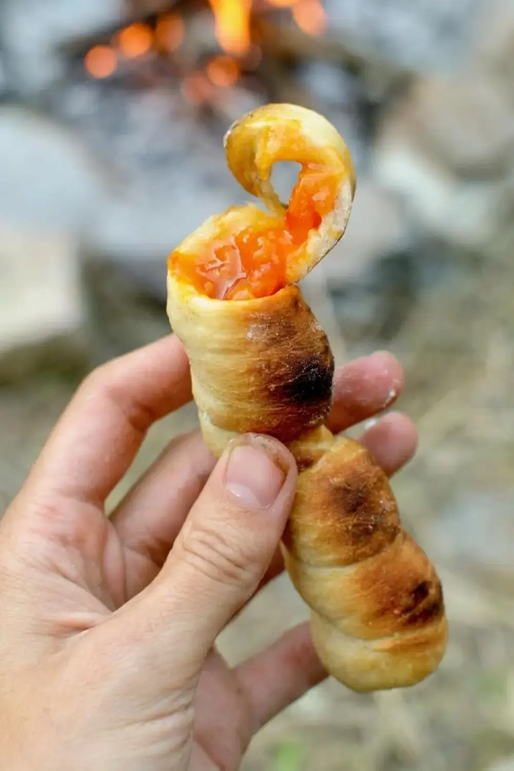 Golden campfire bread finished on a stick