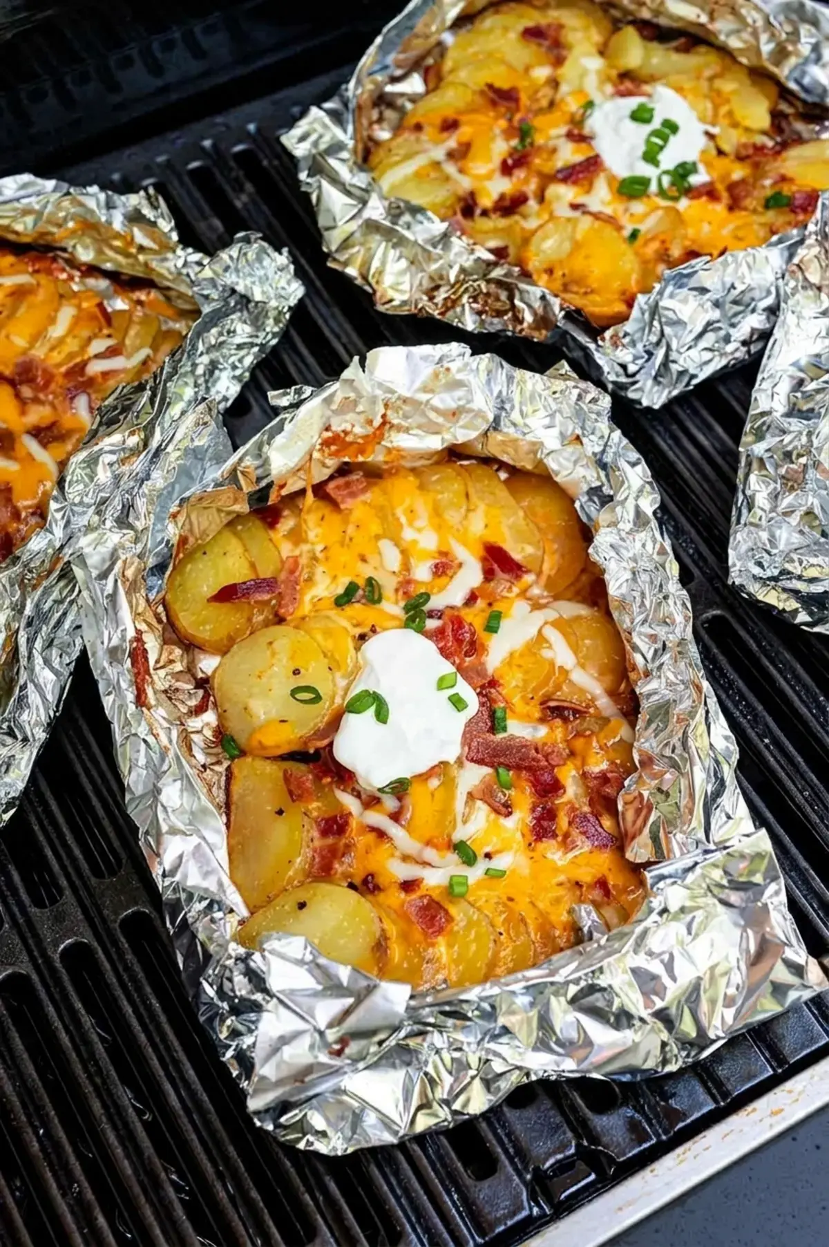 Sealed campfire potato packet cooking on a grate