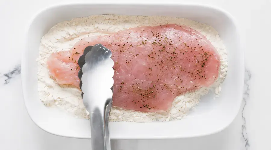 Three bowls arranged for breading chicken