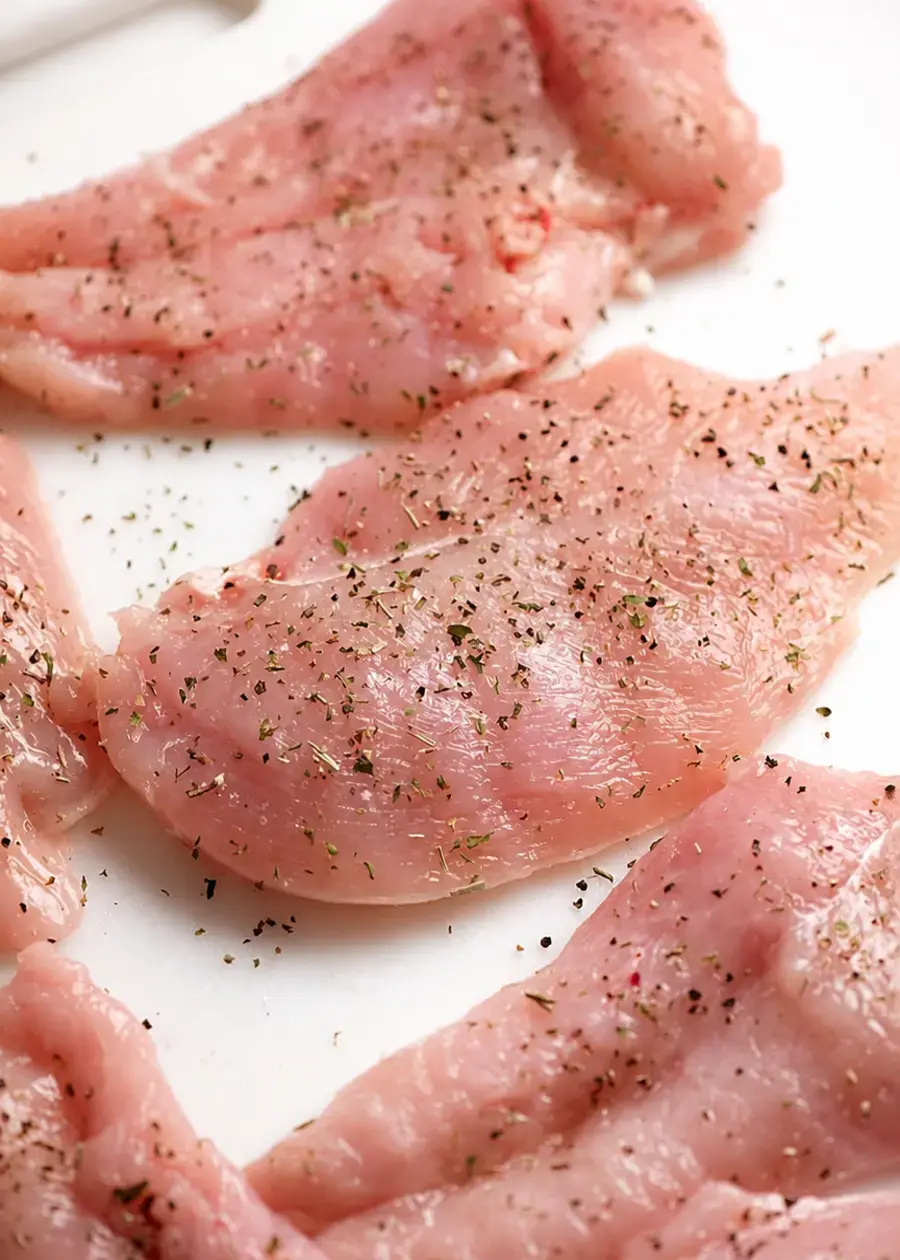 Thin chicken pieces seasoned for dry brining