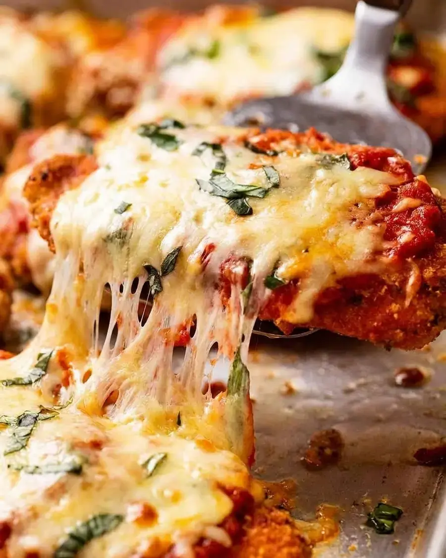 Sliced Chicken Parmigiana showing juicy chicken