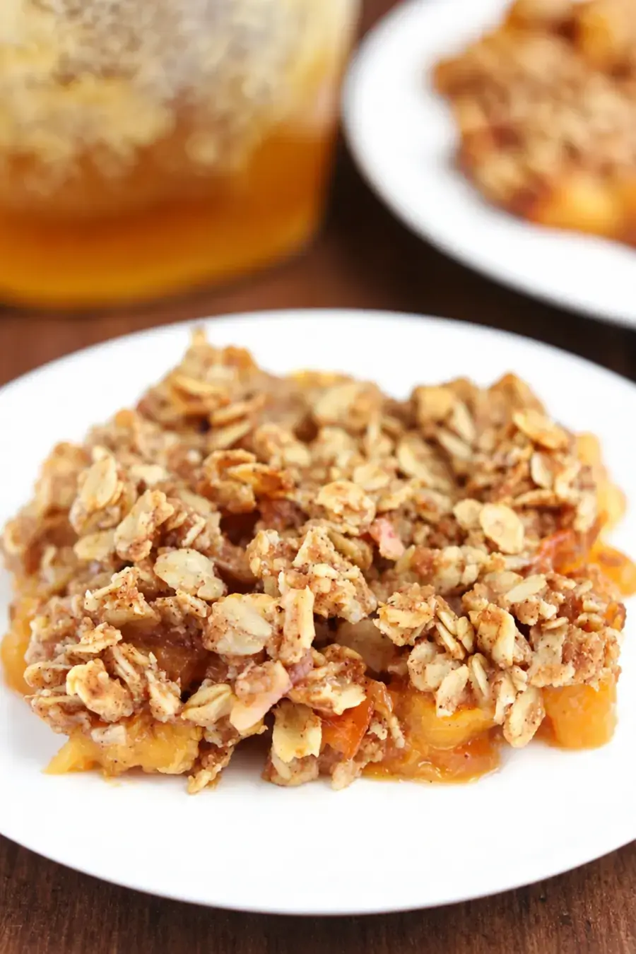 Clean Peach Crumble With Juicy Fruit and Oat Topping 16 Peach filling covered evenly with oat crumble topping