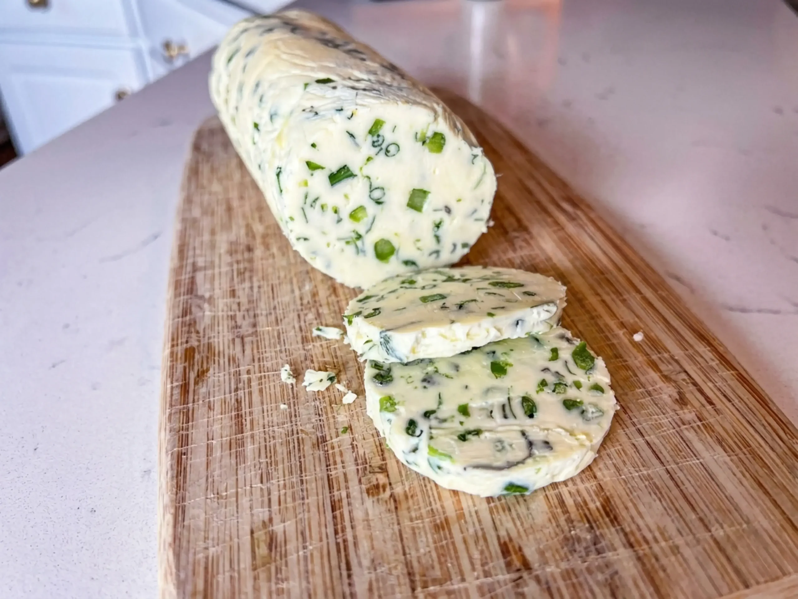 Make Garlic Scape Compound Butter: Recipe, Method, and Tips 7 Herb butter placed on plastic wrap for shaping