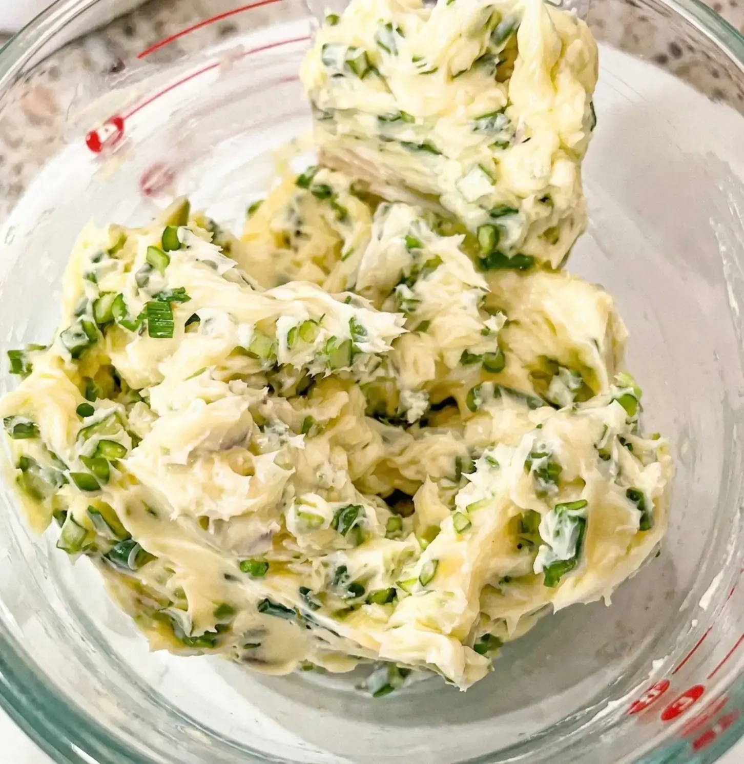 Make Garlic Scape Compound Butter: Recipe, Method, and Tips 1 Garlic scape compound butter with fresh garden herbs
