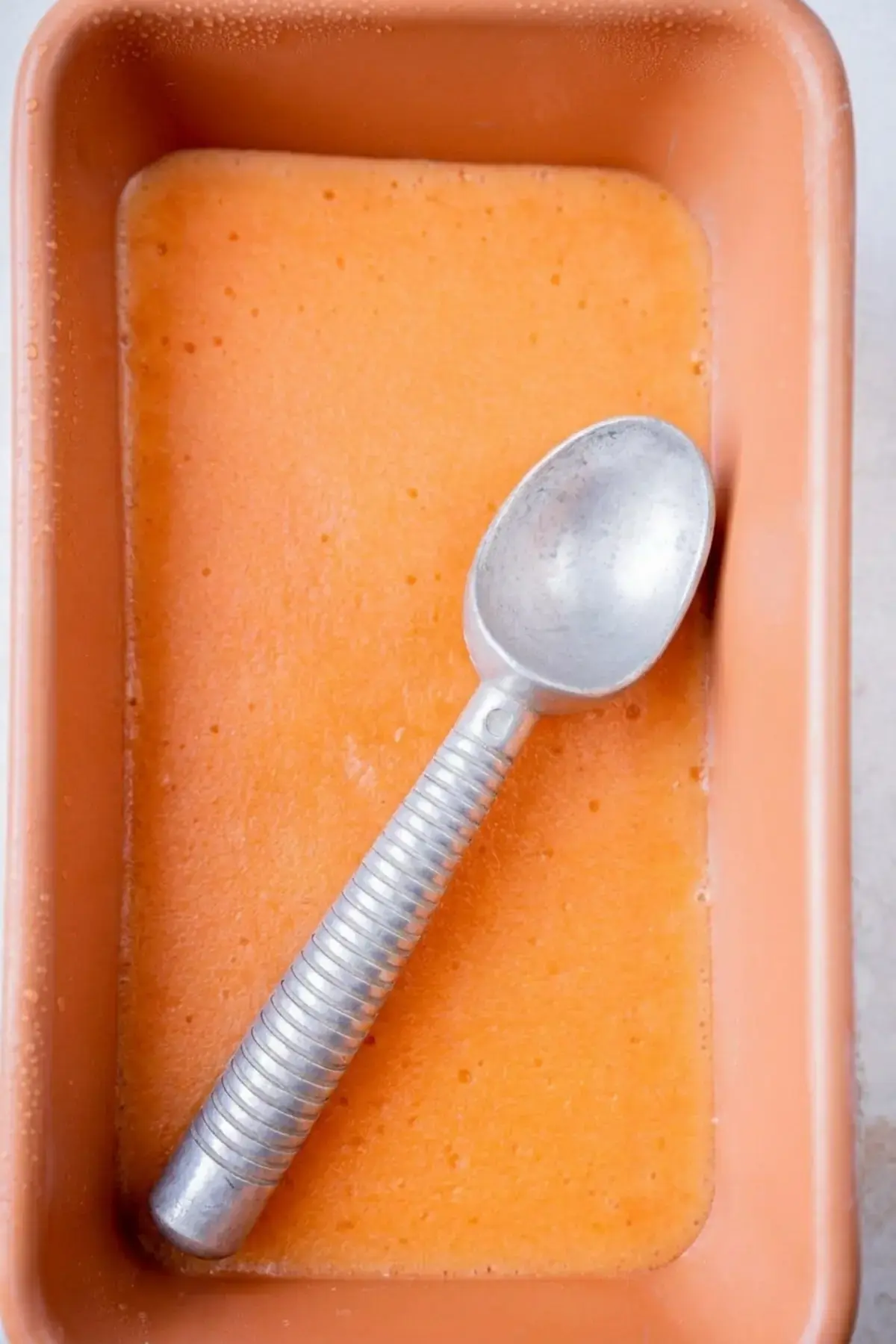 Metal loaf pan covered before freezing sorbet