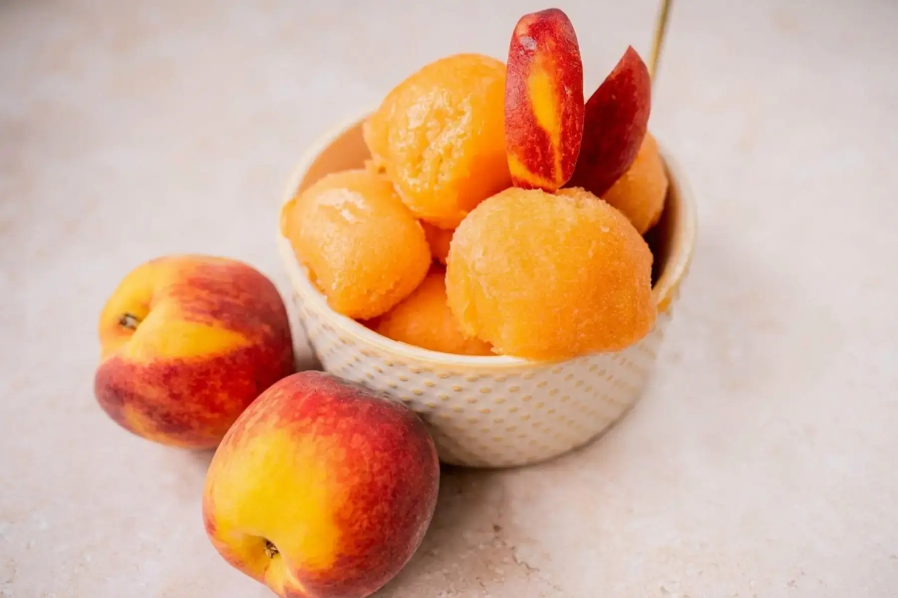 Peach slices placed in a blender container