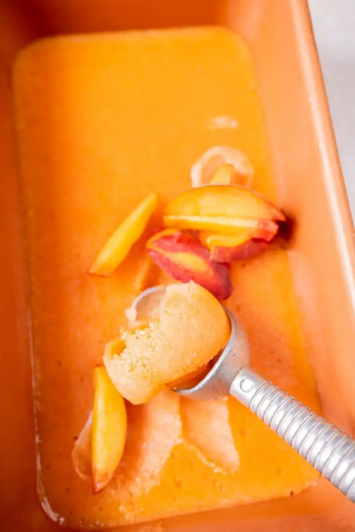 Smooth scoops of homemade Peach Sorbet ready to serve