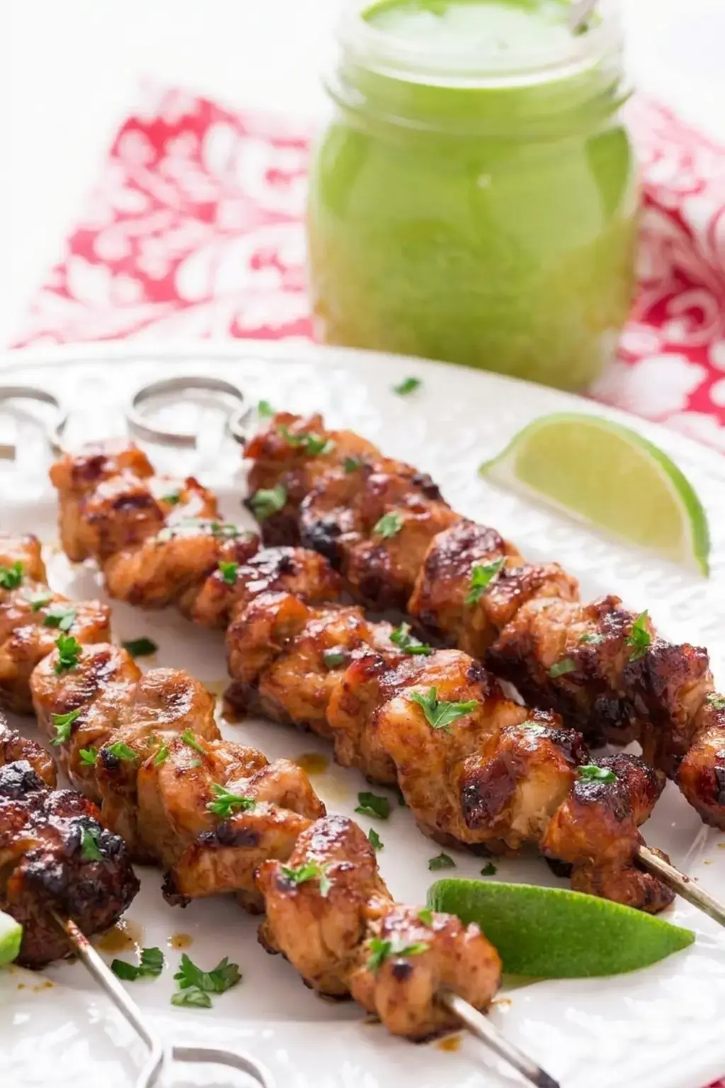 Peruvian Grilled Chicken Skewers with Lime and Ginger 5 Chicken skewers cooking on a hot grill
