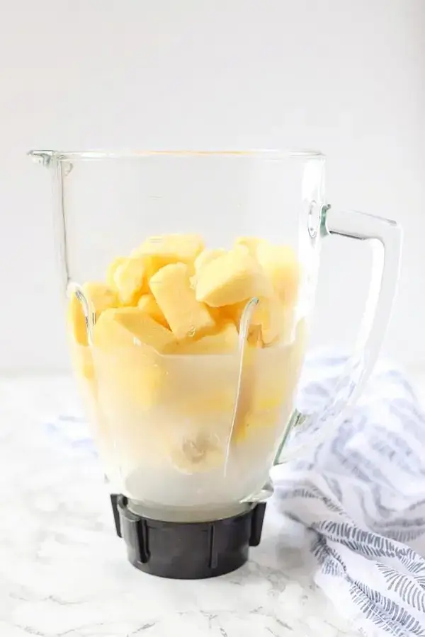 Coconut milk banana pineapple and honey in a blender