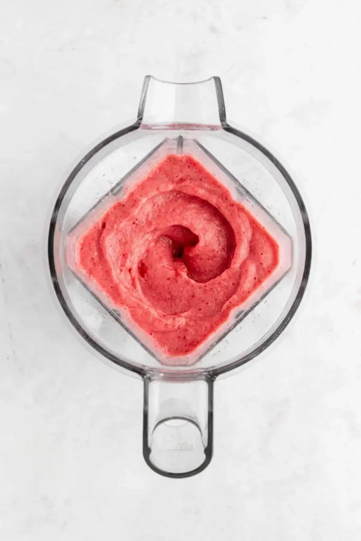 Strawberry Banana Smoothie Bowl 5 Frozen fruit blending into a thick creamy mixture