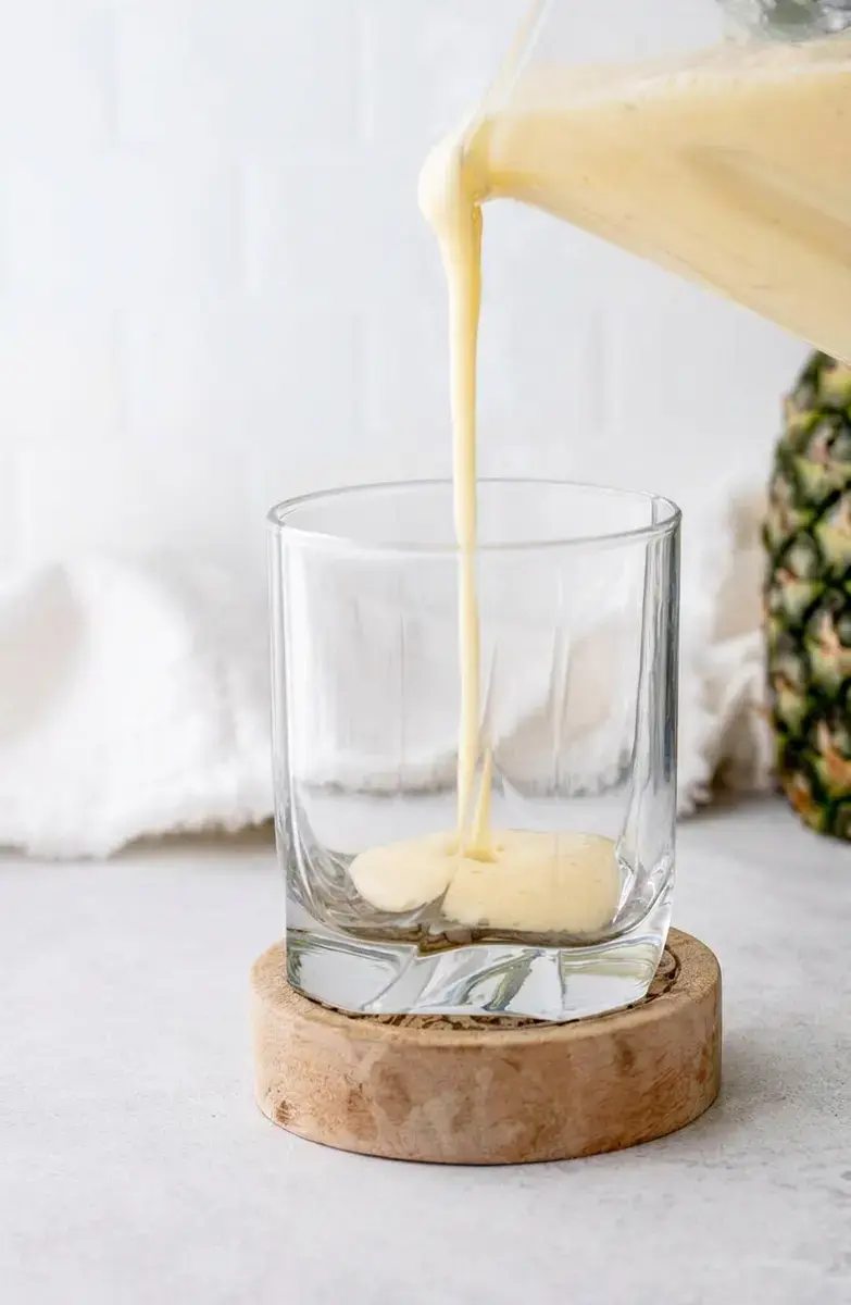 Tropical Almond Colada Smoothie With Pineapple and Coconut 5 Smoothie ingredients layered in a high-power blender
