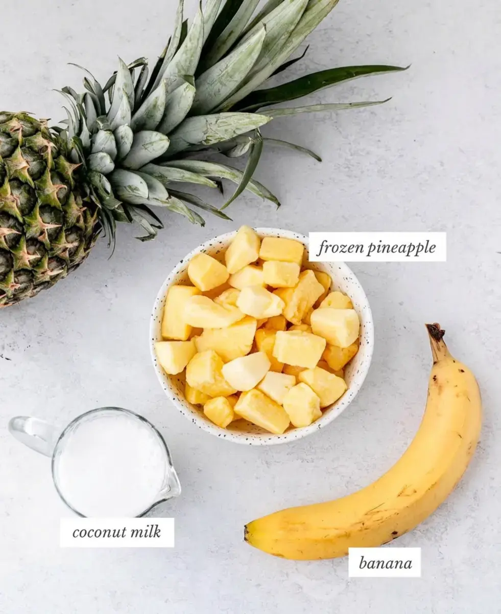 Tropical Almond Colada Smoothie With Pineapple and Coconut 2 Coconut milk and fruit ingredients for a tropical smoothie