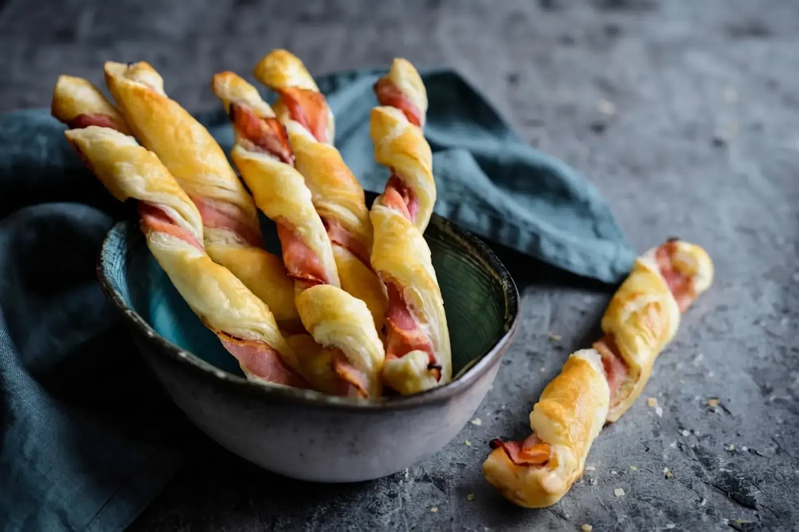 23 Easy Puff Pastry Appetizers, 18) Caramelized Onion and Bacon Puff Pastry Twists